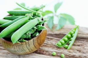 fresh peas in a wooden bowl