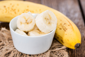 Banana Slices in a small bowl (on vintage background)