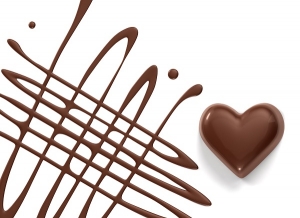 chocolate syrup and chocolate heart isolated on white